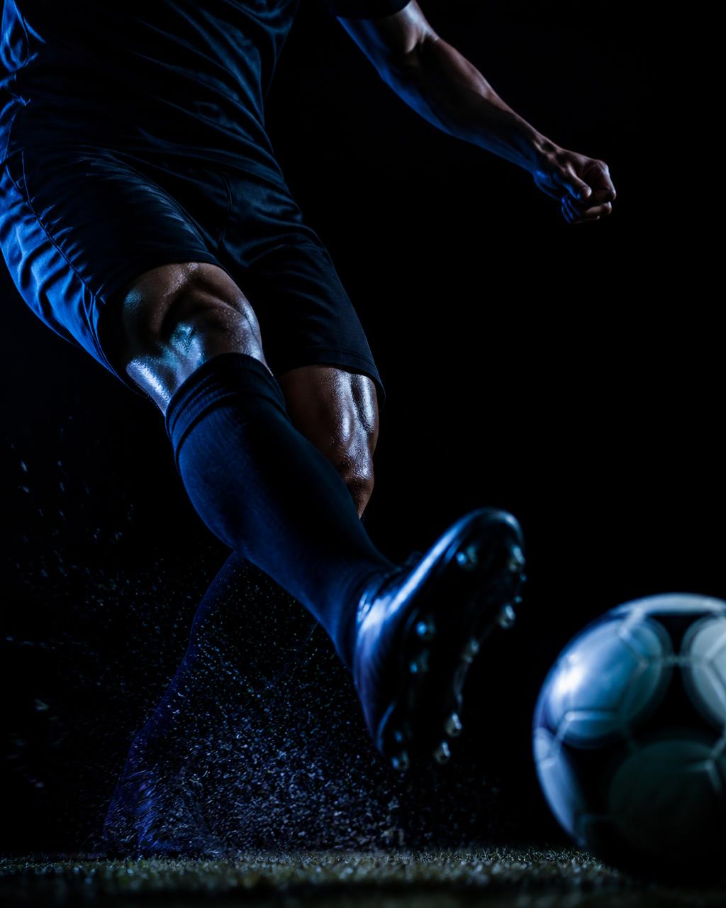 Player striking a precise pass with the ball at his boot